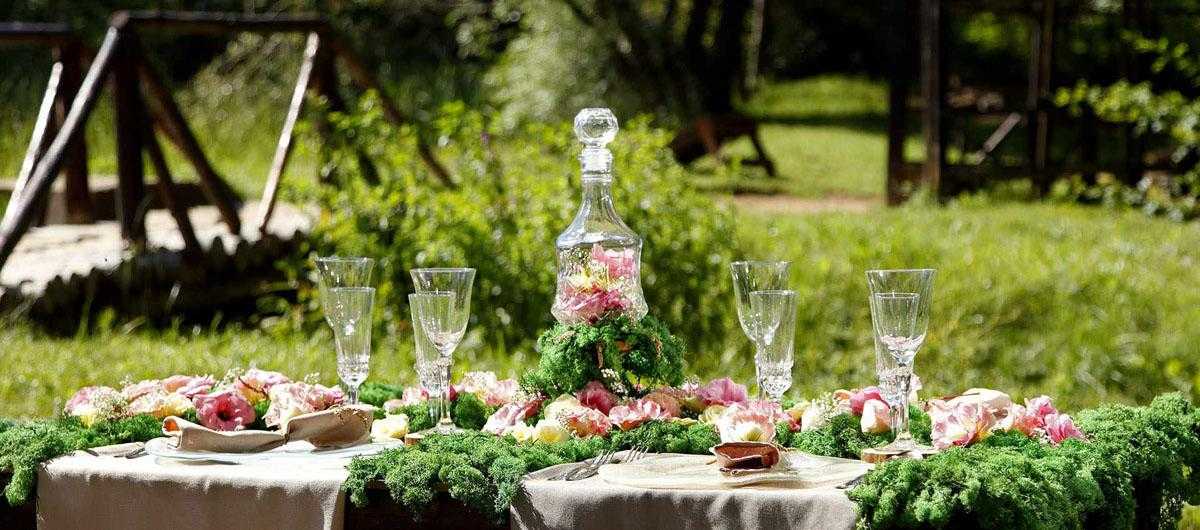 A floral tablescape with lots of greenery and elegant floral decorative plates by AnnaVasily.