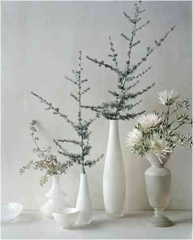 Wintery Natural Elements white vases with lovely branches of pine and other winter trees