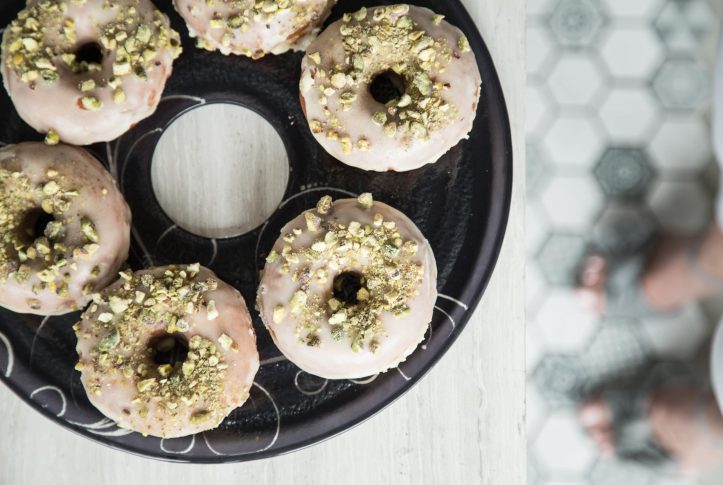 Pistachio donut display on blue tray Selen for donut day.
