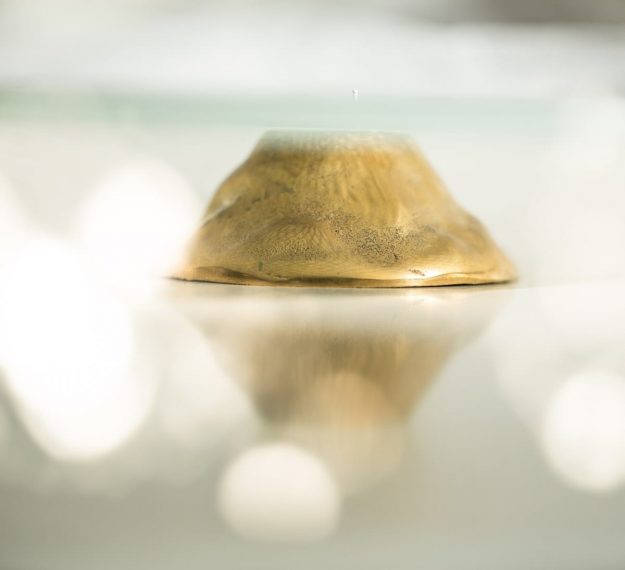 Close up of Polished Brass Pedestal Cake Stand Harmo by Anna Vasily