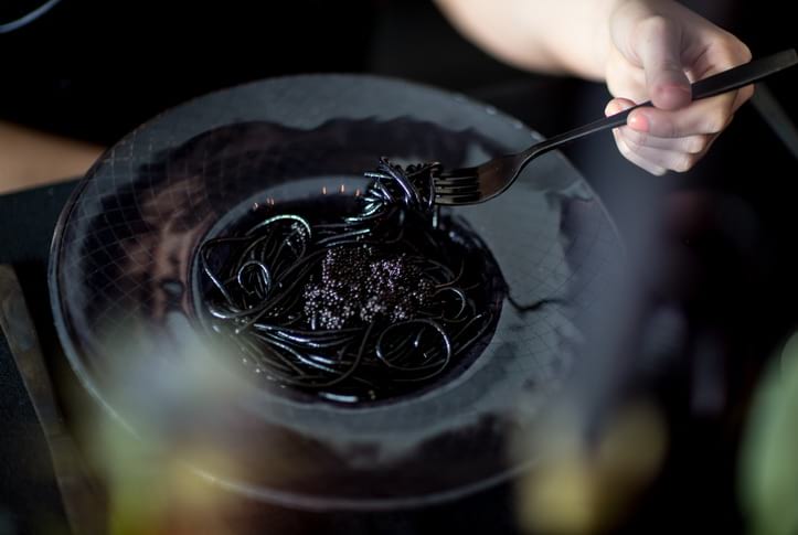 Halloween Dinner Party table settings with the Kristi black pasta bowls with squid ink pasta.