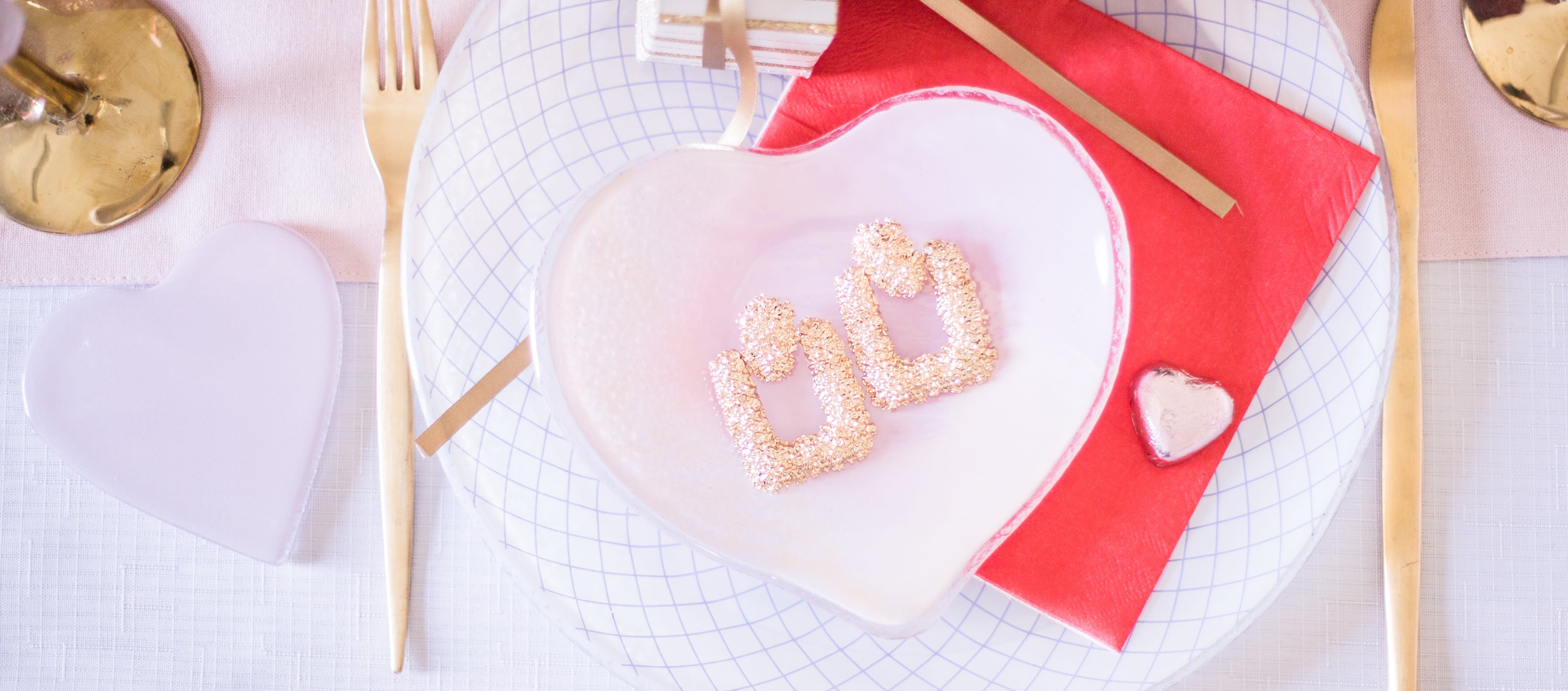 Galentine's Day Table Setting - All pink table setting with heart-shaped plates lots of champagne! Get ideas for your Galentine's Day party from our blog!